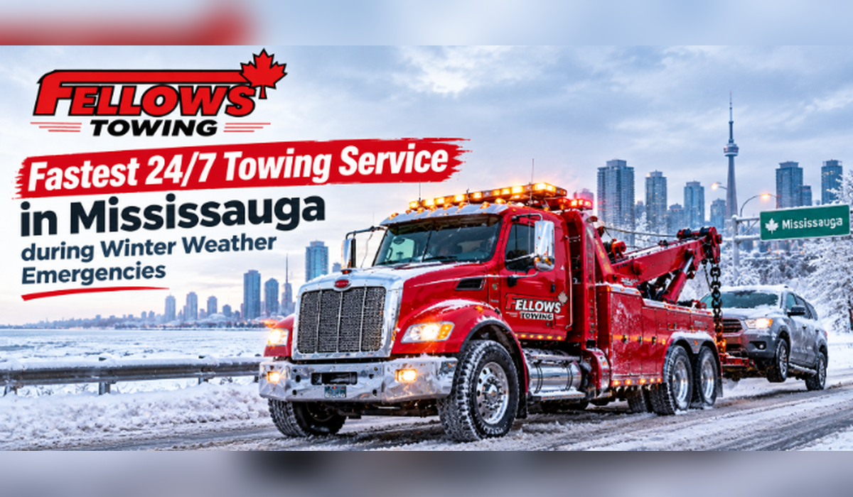 Fellows Towing red heavy-duty tow truck towing an SUV on a snowy road in Mississauga with the Toronto skyline behind